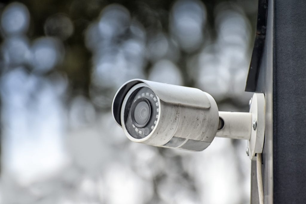 Security system of outdoor video surveillance, CCTV Security Camera on blurred outdoors background.